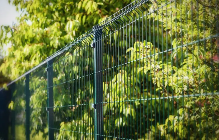 V mesh fencing is a comprehensive, cost-effective security solution that provides excellent security, looks, and value for money. It is considered to be one of the nicest-looking security fences around, with a unique aesthetic appeal that comes from its unique profile and design. The panels have V shapes pressed into them that not only add to the overall look of the fence but also increase rigidity, stability, and strength, as well as making it harder to climb. (as image shown)
Our V Mesh Fencing (also known as ultra mesh fencing) is made from 5mm steel wire that is incredibly difficult to cut with standard tools.
On top of this, it is very hard to climb over and very resilient to direct attack (such as someone driving a car straight at it at speed). The open mesh design of the panels means that you and your security system have a clear view of what is happening on the opposite side. This fencing type is widely chosen for its neat appearance, low maintenance requirements, and compatibility with a variety of access control systems.
Which type of mesh security fencing is right for you depends on your specific needs and budget. Our other fences include our prison mesh, bow top railings and palisade fencing.
For high-traffic or sensitive areas, v mesh can be paired with pedestrian and vehicle access gates, post caps, and tamper-proof fixings to provide a complete fencing solution that meets both safety and operational needs.
Why choose IMS v mesh security fencing:
Strong yet lightweight welded mesh construction
V-pressed profiles for improved rigidity
Galvanised and coated options for corrosion resistance
Compatible with a range of fixing methods and gate systems
Fast to install with minimal disruption on site
Available in various panel heights and mesh thicknesses to meet different security grades
Supplied with optional accessories for streamlined installation, including brackets, clips, and post caps
Contact us today to learn more about our range of mesh security fencing and to get a free quote.